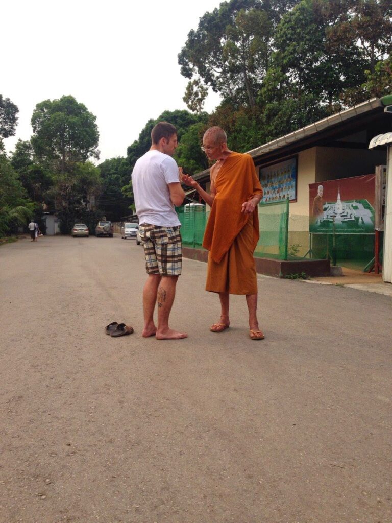 venerable monk giving advice to foreigner in Thailand